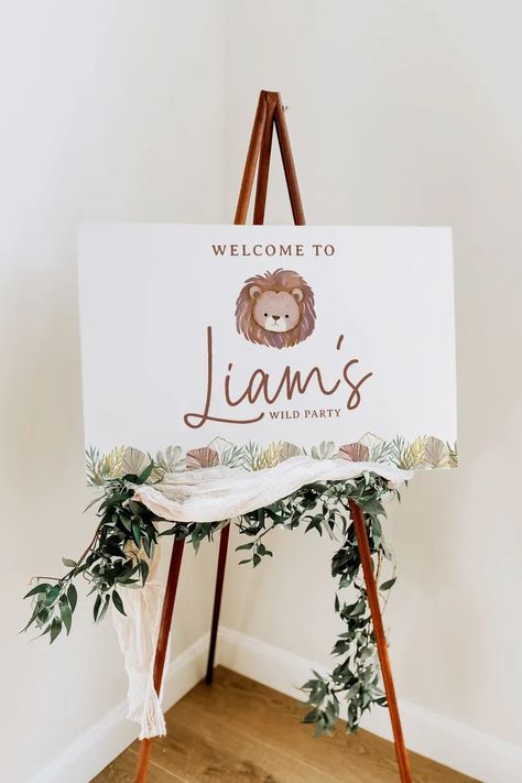 Welcome your little adventurer's guests with our Boho Jungle Safari Lion Birthday Welcome Sign. With the editable features, you can personalize and download instantly, adding that special touch to your wild one's birthday party. The design features a playful lion, leafy greenery, and bohemian elements, perfect for a wild and fun-filled celebration. This digital printable is easy to print, enhancing any jungle, safari, or wild one themed party decor with bohemian charm. Simple Wild One Birthday Decor, Safari Birthday Party One Year, Lion 1st Birthday Party Ideas, Lion Themed Birthday Party, Lion Birthday Theme, Wild One Birthday Theme, Jungle Birthday Party Decorations, 1 Year Birthday Party Ideas, Lion Birthday Party