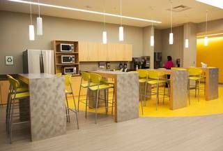 Break room on the yellow floor at Perceptive Software, 8900 Renner Rd., in Lenexa. Lunch Area Office Break Room, Staffroom Ideas, Corporate Kitchen, Office Perspective, Break Room Design, Teachers Lounge Makeover, Office Kitchens, Canteen Design, Office Canteen