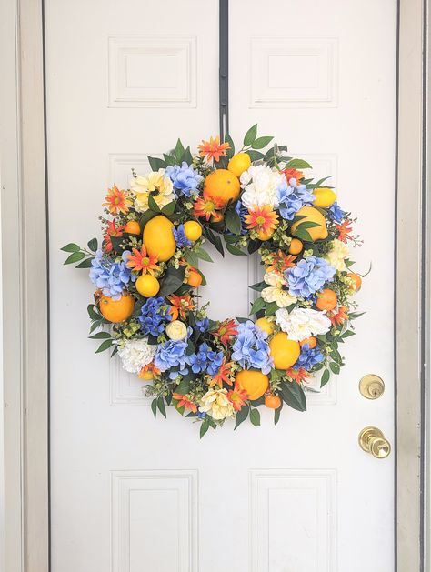 Summer season is slowly approaching change up your to decor with this one of a kind stunning citrus wreath with blue hydrangea. This wreath have two different sizes of lemon, and oranges. With different type of floral and citrus all the texture and color of this wreath compliment each other so well. From blue, yellow, orange, green,and a little bit of cream this wreath will make a big statement piece at your front door. Wreath will look beautiful from spring until summer time! - This wreath is a Spring Summer Decor Home, Late Summer Decor, Wreaths For Funerals, Fruit Wreath, Orange Wreath, Floral Door Wreaths, Lemon Wreath, Summer Door Wreaths, Door Wreaths Diy