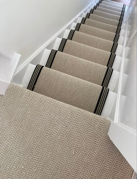 Chalk Herringbone carpet fitted to the stairs as a stair runner and fully fitted on the landing area. The stairs are painted white and the runner is edged in a black and cream stripe tape. Stair Runner Hallway, Cream Runner Stairs, Staircase Ideas Carpeted Runner, Herringbone Sisal Stair Runner, Stair Runner Carpet Top Of Stairs, Landing And Stairs Carpet, Herringbone Runner Stairs, Cream And Black Hallway, Black And Cream Hallway