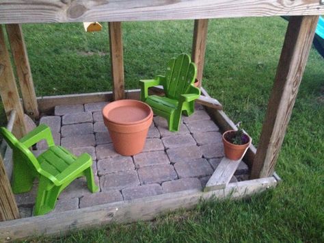 Pavers under the swingset! Made a little tea party area for the girls! Their tea set is inside their terra-cotta pot table! Thinking of adding 2 more chairs for when their friends are over Swing set project! Ideas For Under Swingset, Ideas For Under Playset, Under Playset Ideas Outdoor Play, Play Set Accessories Outdoor, What To Put Under Swingset, Sandbox Under Playset, Playhouse Under Swingset, Under Playground Ideas, Swingset Accessory Ideas