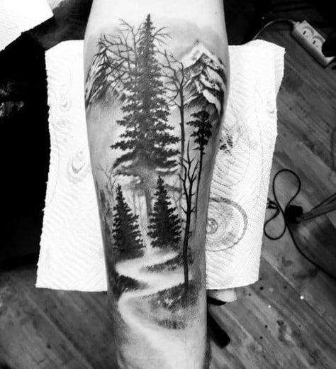 Top 57 Tree Tattoo Ideas [2020 Inspiration Guide] Trees Tattoos For Women, Negative Space Leg Tattoo, Pathway Tattoo Ideas, Trees And Water Tattoo, Forest Path Tattoo, Cool Tree Tattoos, Tree Tattoos For Men, Mountain Sleeve Tattoo, Forest Tattoo Sleeve