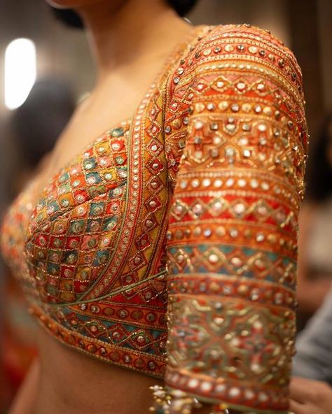 Tarun Tahiliani on Instagram: "𝗧𝗮𝗿𝘂𝗻 𝗧𝗮𝗵𝗶𝗹𝗶𝗮𝗻𝗶 | 𝗗𝗲𝘁𝗮𝗶𝗹𝘀  A closer look at the details of our Phulkari inspired pieces. The gota, mirror work and sequins weave a symphony of summer.   #TarunTahiliani #Craftsmanship #BTS #SOL #Bridalwear #TTBrides #TTBride" Choli Blouse Design, Best Indian Wedding Dresses, Mirror Work Blouse, Embroidery Fashion Detail, Blouse Design Images, Saree Blouse Patterns, Unique Blouse Designs, Tarun Tahiliani, Designer Saree Blouse Patterns