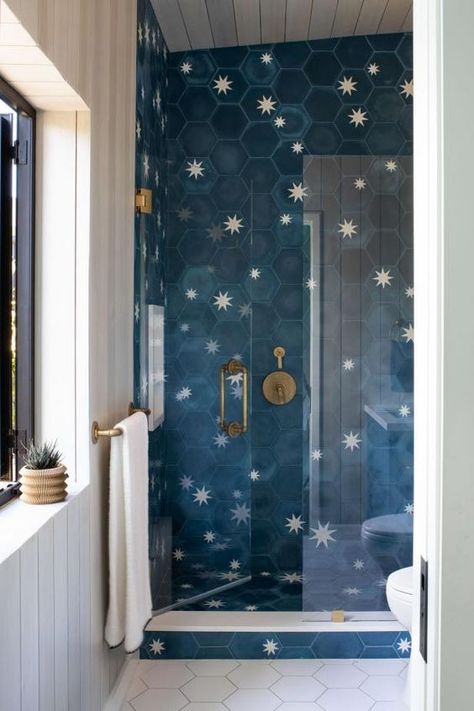 This eclectic bathroom features a funky blue star tiled shower, shiplap walls, and a clean white tiled floor. White Tiled Floor, Modern Coastal Living Room, Funky Bathroom, Modern Kitchen Open, Hgtv Designers, Nautical Living Room, Star Tile, Shiplap Walls, Tiled Floor