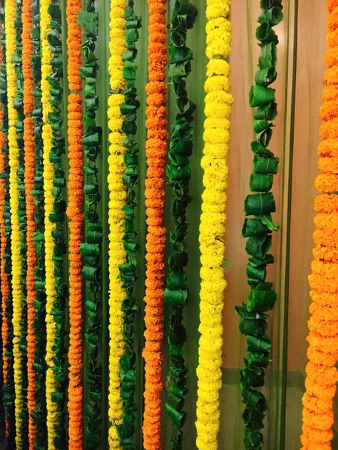 Fresh strings of #marigold and #green #leaves are a sight to behold! #Love this. What do you think? #wedding #picoftheday #bridetobe #weddinghour #happy #lucky #blessed #WedLongAndProsper #groom #family #beautiful #fun #smile #follow #perfect #event #love #marriage #wedding #cute #happiness #happy #follow Ashok Leaves Decoration, Marigold Wedding Decoration, Chath Puja, Indian Floral Decor, Flower Toran, Marigold Wedding, Coaster Diy, Orange Marigold, Pooja Decor