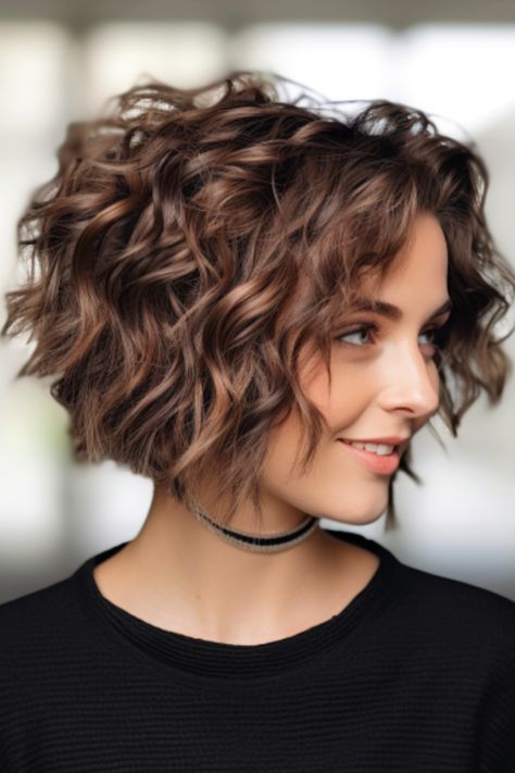 If you’re looking for a timeless look, try a tapered bob with soft ringlets. These soft ringlets will add a bouncy layer to your bob haircut, which can be easily achieved using rollers or a curling iron. Click here to check out more why the bouncy bob is making a comeback: see 28 fabulous examples. Curly A Line Bob Short, Short Hair Body Wave, Graduated Curly Bob, Short Hairstyle Women Fine Curly Hair, Short Layered Curly Hair Natural Curls Bob Hairstyles, Short Bob Haircuts For Round Face, Short Shaggy Haircuts Choppy Layers Fine Hair Bob Hairstyles Curly, Short Bob With Curls, Curly Bob With Side Bangs