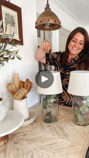 74K views · 6.6K reactions | ✨DIY FRIDAY✨
Here’s a simple diy idea that will add cozy warmth to your home on a budget!

I have to admit I am obsessed with these rechargeable light bulbs & when I saw these glass bottle vases I knew there would be some way I could make them work together! And the great thing is that you can customise these lamps to suit your own home style! I went for a simple look with a sprig of faux eucalyptus & a neutral lamp shade but you could get really creative & add other things to the glass base!

Our master bedroom is still in the stage of re design but these lamps will add the perfect touch & glow to the space!

Glass bottle vase @therangeuk 
Lampshade @therangeuk 
Eucalyptus @homesense_uk 
Rechargeable light bulb @amazon 

Let me know what you think in comments! Diy Bottle Lamp Ideas, Neutral Lamps, Bed Lamp, Rechargeable Light, Bottle Candles, Diy Shades, Rechargeable Lamp, Jar Diy, Bottle Vase