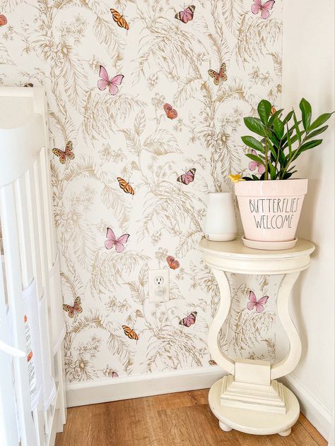 A beautiful nursery with butterfly wallpaper and neutral colors Butterfly Nursery Wallpaper, Butterfly Garden Nursery Theme, Monarch Butterfly Nursery, Wildflower Butterfly Nursery, Butterfly Garden Nursery, Butterfly And Flower Nursery, Baby Girl Nursery Butterflies, Boho Butterfly Nursery, Girl Nursery Butterflies