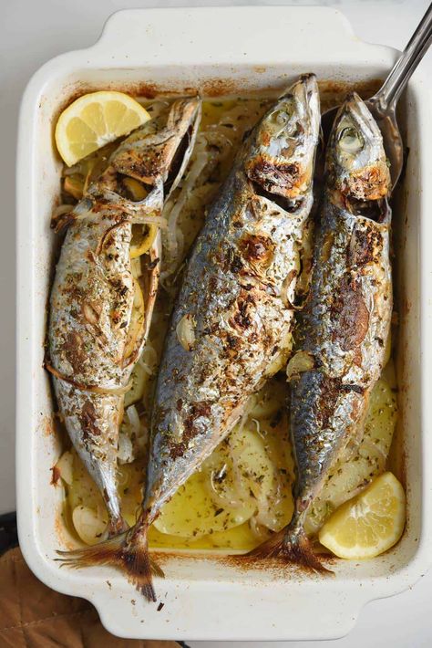 Baked Mackerel With Potatoes And Onions is a super simple and effortless meal. With all the good Greek-style flavors of lemon, oregano, and garlic. + plenty of mellow onions. Whole Mackerel Recipe, Baked Mackerel, Mackerel Recipe, Fish Masala, Potatoes And Onions, Crushed Potatoes, Mackerel Recipes, Mackerel Fish, Potato Slices