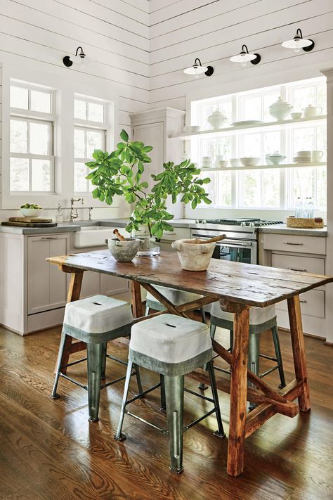 There's no reason to leave any room without an old piece of furniture. For example, this antique trestle table easily serves as an island, a prep station, and a dining table as needed. Add a deep farmhouse sink, and you're set. #homedecor #farmhousestyle #southernliving Lake House Interior, Lake House Kitchen, Charming Kitchen, Cottage Kitchens, Lake House Decor, Island Design, Cottage Kitchen, Wooden Kitchen, Beach Cottages