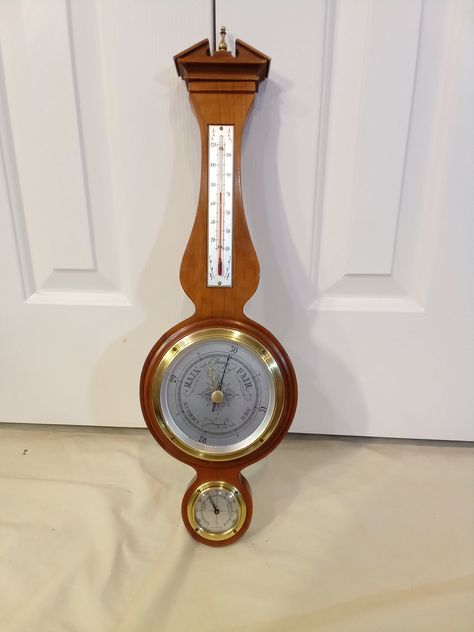 This is a vintage Airguide wall mounted vintage Weather Instrument: Barometer, Thermometer, Hygrometer - Solid Brass Bezels, convex glass covers (no plastic Made in Chicago, in Working Condition, all in a nice dark cherry stained wood case and topped by a solid brass finial. There is a mounting hole for hanging this unit on a wall and the hole is just opposite the top of the thermometer. The barometer has a brass bezel holding the bevel glass front cover, with a brass knob and brass pointer need Cherry Stain, Weather Instruments, Brass Knob, Barometer, Hygrometer, Stained Wood, Brass Knobs, Wood Case, Beveled Glass