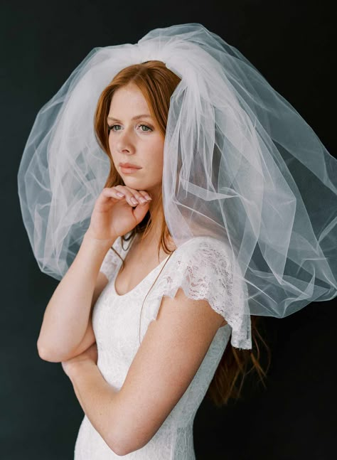 Our nod to the 80s, this bold and dramatic short veil is the perfect amount of pouf and volume for the modern, fashion forward bride! It can be fluffed and shaped for more or less volume as desired. Veil measures approximately 23 inches long and 45 inches wide. Available in white, diamond white, light ivory and ivory Bridal illusion tulle Handmade in our studio Finished on a gold plated wire comb Unsure of the color? Purchase a tulle swatch HERE ***White and Ivory are currently ready to ship. Di 1960s Wedding Hair With Veil, Short Poofy Veil, Short Veils Bridal Vintage, Veil With Short Hair, Poofy Veil, Bouffant Veil, Short Wedding Veils, Bubble Veil, 80s Wedding