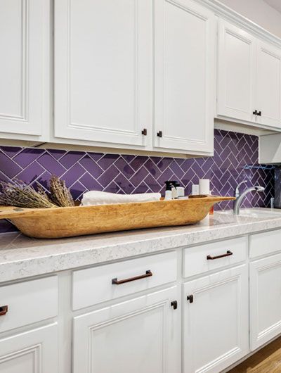 23 Purple Tile Design Ideas For Your Kitchen & Bath | Sebring Design Build Purple Backsplash Kitchen Tile, Purple Kitchen Backsplash Ideas, Purple Kitchen Tiles, Purple Kitchen Backsplash, Purple Tile Backsplash, Purple Tiles Kitchen, Purple Backsplash Kitchen, Kitchen Ideas Purple, Purple Tile Bathroom