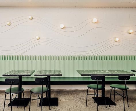 This modern restaurant design uses electrical conduit and keyless lamp fixtures to create attractive wall art that lightly traces the shape of a wave. Dark Restaurant, Eames Dining Chair, Vancouver Restaurants, Surf Town, Taco Restaurant, Modern Restaurant Design, Electrical Conduit, Modern Restaurant, Interior Design Magazine