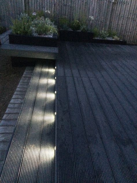 Funky led garden lights. Composite decking in dark grey. Black Decking Ideas Garden, Black Garden Decking, Dark Grey Decking Ideas, Dark Decking Ideas, Dark Grey Decking, Black Composite Decking, Dark Grey Deck, Grey Composite Decking, Decking Lights