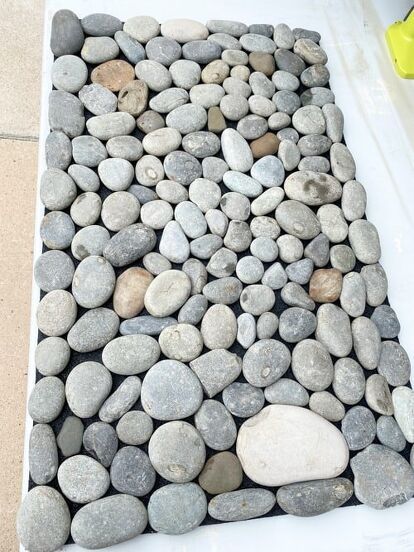 How to create a spa-like feel in your home with this DIY rock mat. Follow this simple tutorial to easily create your own creative piece. Rock Mat, Sauna Kits, Sauna Kit, Smooth Rock, Indoor Sauna, Outdoor Sauna, Floor Ceiling, Plastic Trays, Rubber Mat