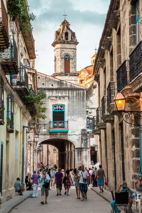 Strolling Calle Obispo, looking toward the Plaza de la Cathedral. The bell tower of the Cathedral of the Virgin Mary can be seen above. Cuban Architecture, Cuba Pictures, Cuba Photos, Cuban Culture, Havana Club, Visit Cuba, Porto Rico, Cuba Travel, Varadero