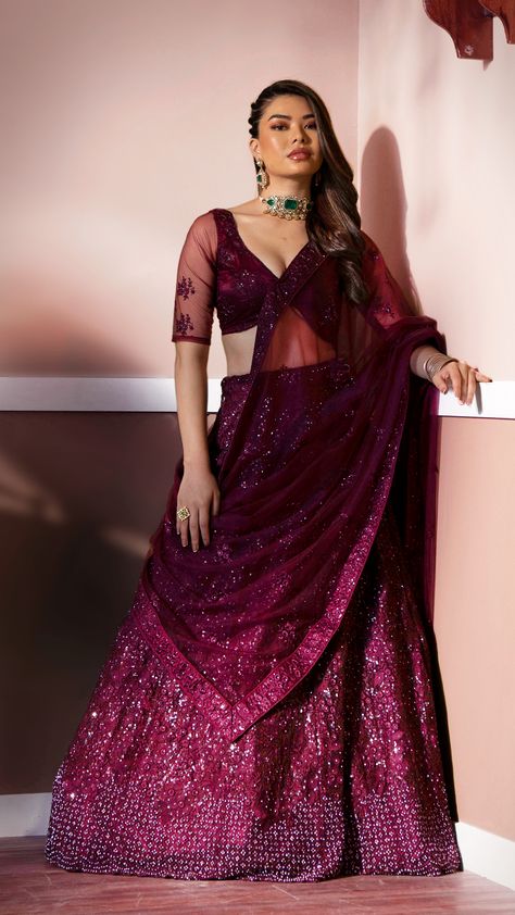 Our wine luxurious embroidered lehenga with illuminating metallic sequins that is threaded into scattered patterns. It is a dazzling outfit which is perfect for a contemporary bride like you! Jewellery With Maroon Lehenga, Wine Lehenga Party Wear, Wine Lehenga Jewellery Ideas Simple, Jewellery With Wine Colour Lehenga, Wine Color Dress Makeup, Wine Colour Lehenga Color Combos, Reception Lehenga For Bride Sister, Maroon Colour Lehenga, Burgundy Dress Outfit Wedding