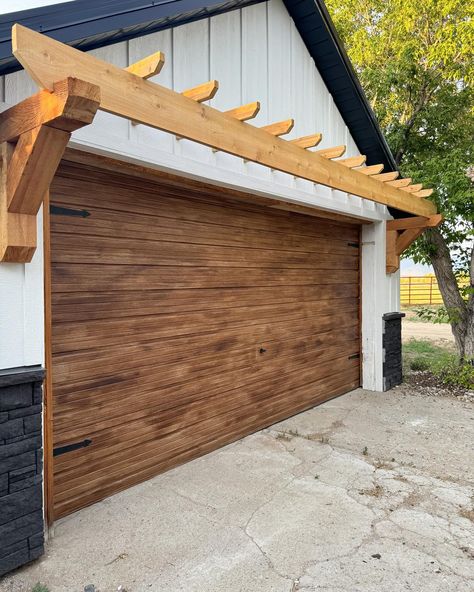 🤌🏻✨ DIY faux wood garage door and I love 😍 painted the garage knob black and added magnetic hinges to finish it off. Next up is new concrete! . . . #garage #exterior #exteriordesign #diy #project #painting #paint #home #homemakeover #garagedoors Faux Wood Garage Door Diy, Painting Garage Doors, Painted Garage Door, Eyebrow Pergola, Garage Pergola Diy, The Sassy Barn, Driveway Paint, Brown Garage Door, Faux Wood Garage Door