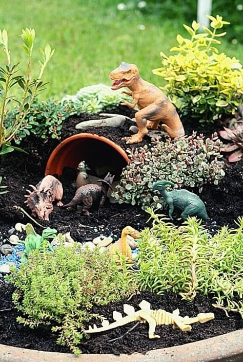 Dino Garden Ideas, Dinosaur Fairy Garden Ideas, Outdoor Dinosaur Garden, Boys Fairy Garden, Dinosaur Garden Ideas, Outdoor Dinosaur Play Area, Dinosaur Fairy Garden, Children’s Garden Idea, Preschool Fairy Garden