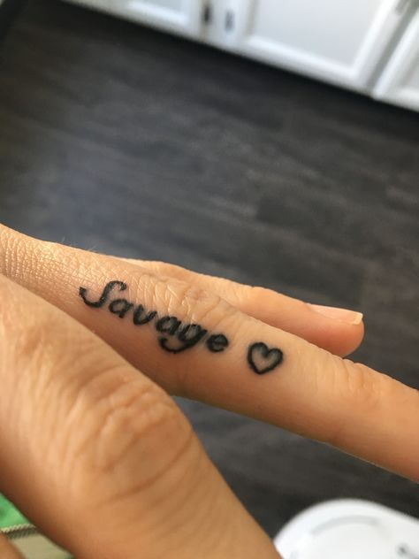 Finger tattoo delicate black tattoo women savage heart ring finger Finger Tattoo Black Women, 21 Savage Tattoo Ideas, Middle Finger Tattoo For Women, Queen Finger Tattoo, Finger Tattoo Ideas Female, Inner Finger Tattoos For Women, Savage Tattoos For Women, Inner Finger Tattoos Words, Encouragement Tattoos