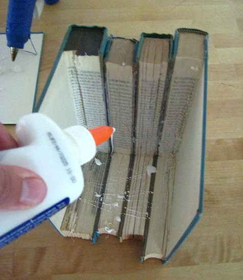 Sit the attached group of books on its bottom edge. Drizzle craft glue liberally onto the exposed cut pages, using a brush to coat them. (This will prevent the books from opening.) Wrap rubber bands around the group to hold the books together as they dry. Allow to dry completely (at least overnight).  - WomansDay.com Book Recycle Diy Projects, Crafts Using Books, Book Upcycle, Upcycled Books Crafts, Wicked Crafts, Decorative Columns, Page Crafts, Book Art Projects, Old Book Crafts