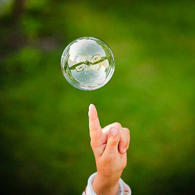 Add 1 cup of dishwashing soap to a gallon of warm water. An extra two to three tablespoons of glycerin, is the secret to super-big bubbles. Pour your concoction into a flat, rimmed tray, like a sheet-cake pan. Make a wand by bending a wire hanger into a loop. Teach your toddler to lift the wand slowly and walk backward to let loose a gigantic bubble. You can experiment with making different kinds of wands with straws, pipe cleaners, even fly swatters. Diy Bubbles, What To Do Outside, Outdoor Science, Bubble Making, Silly Monsters, Outside Fun, Fly Swatters, Outdoor Activities For Toddlers, Bubble Solution