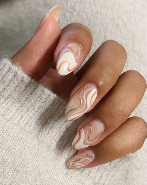 Hand showing almond shaped nails with nude pink and base; the nails have gold white and peachy designs that are curvy lines. Peach And Cream Nail Designs, Gold And Peach Nails, Peach Marble Nails, Peach Glazed Nails, Peach Swirls Nails, Sns Nails Designs, Marble Nail Designs, Sns Nails, Jelly Nails