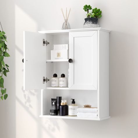 PRICES MAY VARY. Large Storage Space: This OONNEE 24" W x 30"H x 9" D bathroom wall cabinet has a large open storage space at the bottom for easy access or display and large storage space with an adjustable shelf behind 2 doors. The shelf can be adjusted to 3 different heights for customizable storage space. A great over toilet space saver storage cabinet Elegant Wall Cabinet with Classic Metal Handle: Classic metal door handles add elegance to this white bathroom wall cabinet. The wall mounted Hanging Bathroom Cabinet, Above The Toilet Storage, Storage Cabinet Wall, Over Toilet Storage Cabinet, Toilet Storage Cabinet, Over Toilet Storage, Wood Medicine Cabinets, Bathroom Wall Cabinet, Large Storage Cabinets