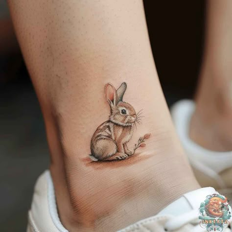 This lifelike small bunny tattoo is the epitome of cute tattoo ideas, nestled quietly on the skin, it’s perfect for animal lovers. For more cute tattoo designs, hop over to inktat2.com. Rabbit Butterfly Tattoo, Rabbit Tattoo Ideas For Women, Floppy Bunny Tattoo, Watercolor Bunny Tattoo, Realistic Bunny Tattoo, Bunny Tattoos For Women, Fine Line Rabbit Tattoo, Baby Bunny Tattoo, Honey Bunny Tattoo