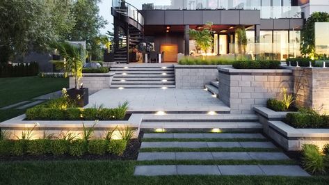 The top exterior home trends for 2023 | Techo Bloc Patio Paving, Patio Stone, Terraced Backyard, Garden Retaining Wall, Patio Slabs, Driveway Landscaping, Landscape Stone, Tiered Garden, Paving Slabs