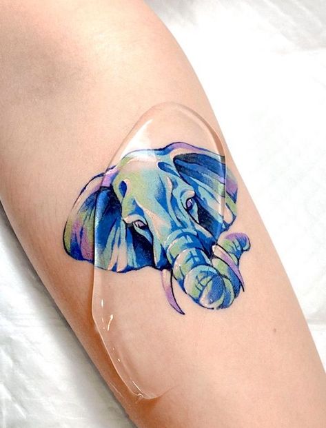 57 Unique Elephant Tattoos With Meaning - Our Mindful Life Blue Elephant Tattoo, Unique Elephant Tattoos, Miniature Tattoo, Eden Tattoo, Twilight Tattoos, Elephant Family Tattoo, Baby Elephant Tattoo, Paper Plane Tattoo, Tiny Elephant Tattoo