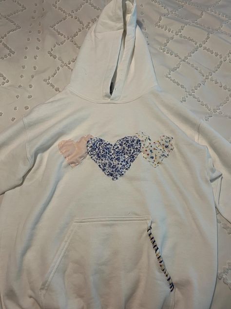 Heart Sewn Hoodie | This sweatshirt comes with multiple, customizable colors and fabrics and is sewn by hand. Because each sweatshirt is handmade, no two sweatshirts are alike. Custom stitching is also chosen by designer to match fabric. Cute Best Friend Matching Outfits, Viral Heart Hoodie, Diy Hoodie Iron On Ideas, Stitch Work Hoodie, Hobby Lobby Hoodie Diy, Fabric Sweatshirt Design, Embroidered Heart Sweatshirt, Hoodies With Embroidery, Heart Patch Hoodie