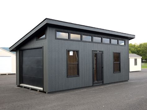 12x24 Lancaster Garage w Smart Panel T111 Siding - Modern Shed Collection- Pressure treated skids- 2x4 Pressure treated floor joists 8" O.C.- 3/4" Flooring- 2x4 walls 16" O.C.- 2x6 rafters 16" O.C.- 7&apos;1" high rear wall- 10&apos;1" high front wall- Mitered trim package- Two 30x54 Grid-less windows with screens- 7-35" Grid-less Transoms on front high wall- Two Trapezoids on gables- 3&apos;x78" Modern door- 9x7 Flush Panel Garage Door- 3/12 roof pitch- 1 Small Garage Bedroom Ideas, 12x24 Shed Plans Layout, Modern Storage Shed Plans, Modern Garage Storage Ideas, Stand Alone Garage Ideas, Shed Layout Ideas, Single Car Garage Ideas, Modern Garage Design Interior, Shed Roof Garage