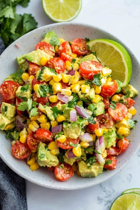 This avocado corn salad is bursting with color and freshness! With a tangy lime dressing, it's a side dish no one can resist. Corn And Avocado Salad, Avocado Corn Salad, Weight Watchers Salad, Corn Avocado Salad, Corn Salad Recipes, Fresh Avocado, Slaw Recipes, Avocado Chicken Salad, Lime Dressing