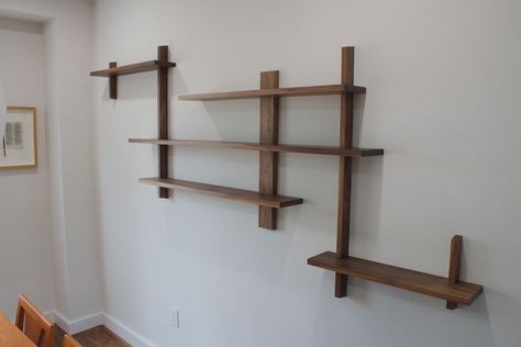 This asymmetrical, Japanese design inspired, dining room shelving was designed with the intention to display to our client’s favourite personal mementos. Made from walnut. It is fastened to the studs in the wall as well as held together with tight wood joinery. Japanese Shelves Design, Japanese Shelf Design, Japanese Shelving, Japanese Shelves, Asymmetrical Shelving, Japanese Shelf, Interlocking Furniture, Asymmetrical Shelves, Dining Room Shelving