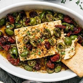 Mediterranean Baked Feta Mediterranean Baked Feta Downshiftology, Mediterranean Baked Feta Dip, Spicy Baked Feta Dip, Feta Olive Bake, Warm Feta Dip With Marinated Olives, Mediterranean Diet Party Food, Mediterranean Feta Dip, Mediterranean Baked Feta, Feta Dishes