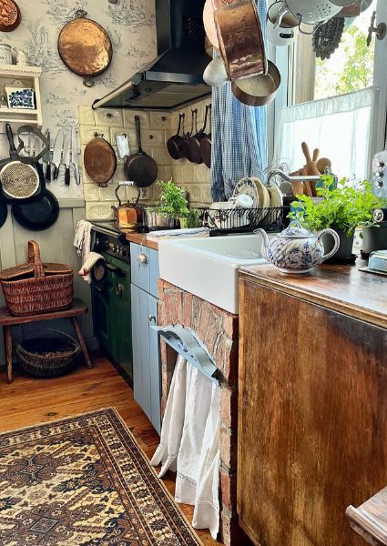 Bring a touch of whimsy to your kitchen with cottagecore inspired design ideas. From pastels to vintage accents, create a cozy cooking space. Small Vintage Kitchen, Unfitted Kitchen Ideas, Hobbit Kitchen, Cottagecore Kitchen Ideas, Kitchen Sage Green, Cottagecore Kitchens, Kitchen Armoire, Antique Decor Ideas, 1940s Interior