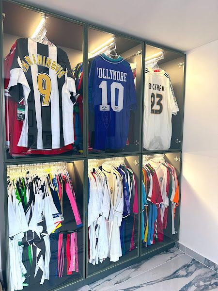 Football Collection Display, Jersey Storage Ideas, Football Shirt Display Ideas, Soccer Jersey Display Ideas, Football Bedroom Aesthetic, Framed Football Shirts On Wall, Soccer Man Cave, Framed Football Jersey, Jersey Collection Display