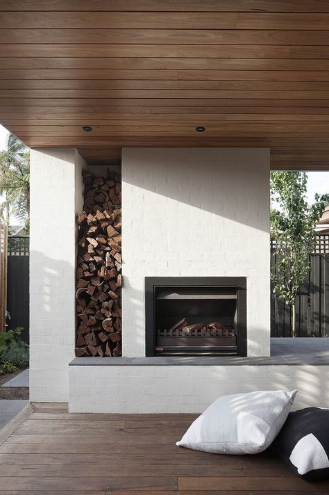 An outdoor fireplace with built-in firewood storage. When Stephen Mendel—co-owner of Australian furniture company Globe West—and his wife bought a rundown 1960s house in the Melbourne suburb of Caulfield, the design-savvy pair knew what they wanted. Experienced remodelers, they had previously worked with Bower Architecture, and turned to the designers to bring their program to life once again. Modern Outdoor Fireplace, 1960s House, Outdoor Fireplace Designs, Fireplace Built Ins, Outdoor Kitchen Design, Fireplace Mantle, Modern Landscaping, Fireplace Design, Wood Storage