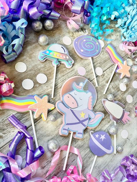 Complete your Out of This World space theme birthday with these layered cupcake toppers! Embellishments include planets, space shuttles, flying saucer, rainbow shooting stars, white irridescent stars, galaxies, and space unicorns. Space Unicorn Party, Space Party Favors, Unicorn Garland, Planet Birthday, Unicorn Birthday Decorations, Space Party Decorations, Birthday Cupcake Toppers, Outer Space Birthday, Unicorn Party Favors