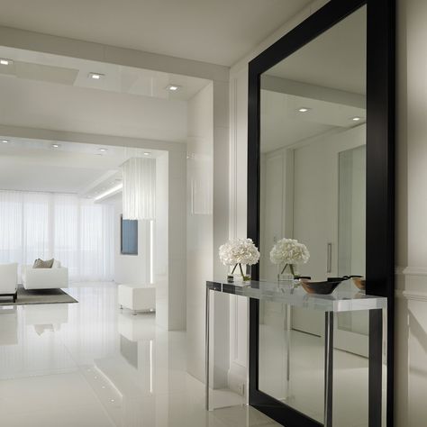 Miami is known for its vibrant culture, stunning beaches, and stunning architecture. With so many talented interior designers and professionals in the... Decoration Hall, Contemporary Hallway, White Wall Paint, Modern Foyer, Hallway Mirror, White Tile Floor, Entryway Mirror, Hallway Designs, Hallway Design