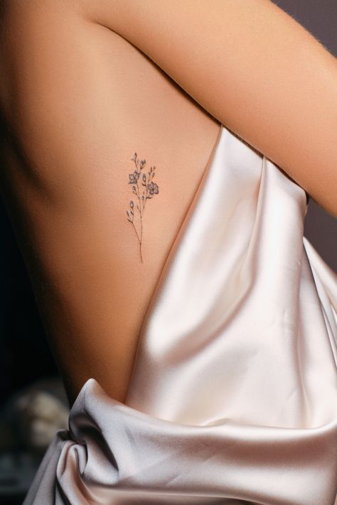 Hip Tattoos Women Minimalist, Cool Placement For Tattoos, Small Fine Line Hip Tattoo, March Month Tattoo, Elegant Simple Tattoos, Rib Floral Tattoos For Women, Delicate Rib Tattoo, Flower Tattoos Rib Cage, Delicate Flower Tattoo Ribs