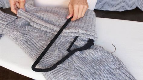 Use this genius method to neatly hang sweaters in your closet without stretching out the material. How To Fold Sweaters, Sweater Hangers, Hang Sweaters, Sweater Hanging, Simple Closet, Shirt Folding, Clothes Organization Diy, Organisation Hacks, How To Hang