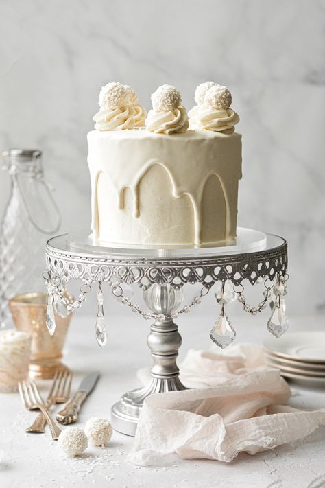 A beautiful white chocolate cake that's perfect for any special occasion! Fluffy layers of white velvet cake are frosted with luscious white chocolate buttercream, covered in white chocolate ganache drip, and topped with truffles for a pretty finish. White Chocolate Drip Cake, White Chocolate Drip, Almond Wedding Cakes, White Velvet Cakes, Pink Champagne Cake, Ganache Drip, Champagne Cake, White Chocolate Buttercream, Cookies And Cream Cake