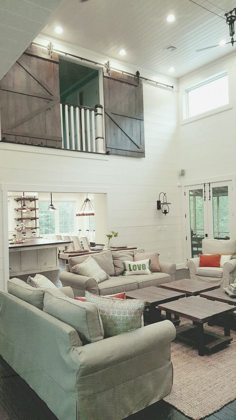 Living room with shiplap walls, lots of windows and barn doors on the loft! Loft Opening Ideas, Loft Above Dining Room, Private Loft Bedroom, Loft Looking Over Living Room, Loft With Half Wall, Open Staircase To Loft, Loft Renovation Ideas, Adding Loft Over Living Room, Closing Off Upstairs Loft