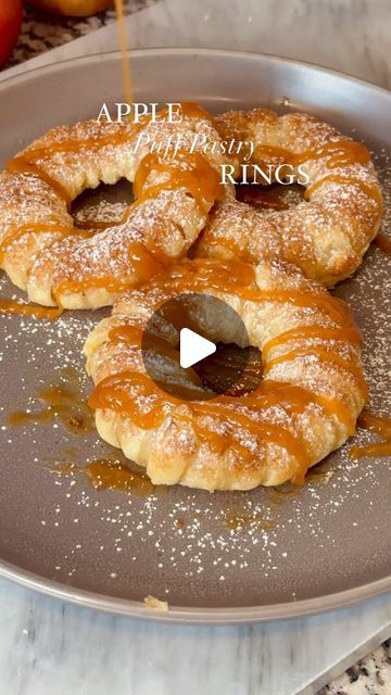 Mary Castro on Instagram: "APPLE PUFF PASTRY RINGS 🍎 - these are a fun way to use up those Fall apples and they’re absolutely delicious!

Ingredients:

1 sheet of puff pastry 
1-2 apples (I used Granny Smith and Honeycrisp)
Heavy cream (for brushing on the rings)
1/2 Tbsp cinnamon 
1/4 cup of sugar 
Optional:
Powdered sugar
Caramel sauce
Ice cream 

1. Preheat oven to 400F
2. Make your cinnamon sugar and set aside 
3. Thaw out puff pastry sheet and roll out
4. Cut 1/2 inch strips
5. cut out rounds from your apples and use a round cookie cutter to cut out the center with the seeds 
6. Wrap each apple ring with strips of puff pastry until covered
7. Brush some heavy cream (you can use milk of your choice as well or an egg wash)
8. Dust the tops with cinnamon sugar and bake in the oven for a Puff Pastry Apple Rings, Apple Rings With Puff Pastry, Apple Puff Pastry, Apple Rings, Puff Pastry Sheets, Pastry Sheets, Fall Apples, Egg Wash, Granny Smith