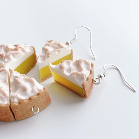 Yes, I’m fully embracing all the pies. Today, lemon meringue! Available right now! Which type of cake or pie should I turn into jewelry next? 🤭🍰 . . . . . . . #polymerclay #handmadejewelry #earrings #foodart #lemon #lemonmeringue #lemonpie #bakingtiktok #cakedecorating #etsyprocess #smallbusiness #sculpey #handmadeearrings #polymerclayearrings #artistsoftiktok #miniatures #desserts #desserttiktok ￼ Drumstick Ice Cream, Pie Earrings, Earrings Food, Pie Slice, Cream Earrings, Pie Tops, Lemon Filling, Banana Cream Pie, Lemon Meringue Pie