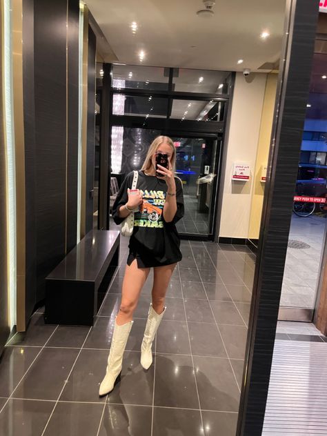 Cowboy boots, mini skirt, t shirt Black Mini Skirt Cowboy Boots, Big Shirt Mini Skirt Outfit, Cowboy Boots With Mini Skirt, Black Skirt Country Outfit, Mini Skirt Big Shirt, Mini Skirt Cowboy Boots Outfit, Cowboy Boots And Skirt Outfit, Cowboy Boots Mini Skirt, Skirt And Cowboy Boots Outfit