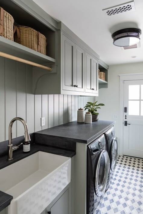 Two-toned concrete tile floors add character to this mudroom-meets-laundry room, with millwork and built-ins painted in a grey hue. Laundry Room Paint Colors, Chic Laundry Room, Efficient Laundry Room, Laundry Room Paint Color, Traditional Laundry Room, Laundry Room Inspo, Laundry Reno, Laundry Room Paint, Laundry Room/mudroom